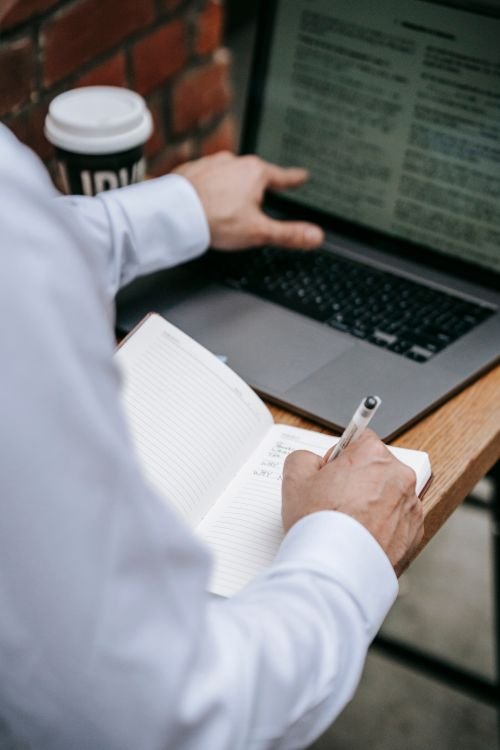 Guest post vs link insertion comparison — writing an article on a laptop desk